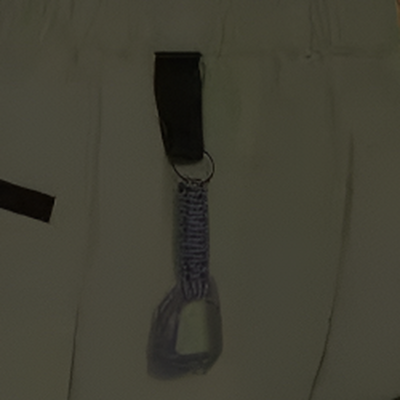 Zipped pocket, elastic waist and pull tab, shown close up